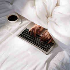 Hands typing on laptop